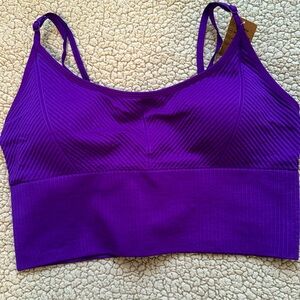 Pink purple lightly supportive sports bra. Never worn with tags! Size medium
